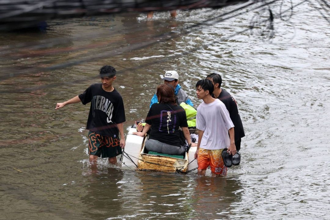 ハバガットによる洪水で冠水した通りを歩く人々（2026年8月、リサール州カインタ）